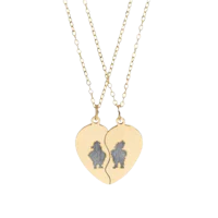 two heart shaped necklaces with a silhouette of a man and a woman